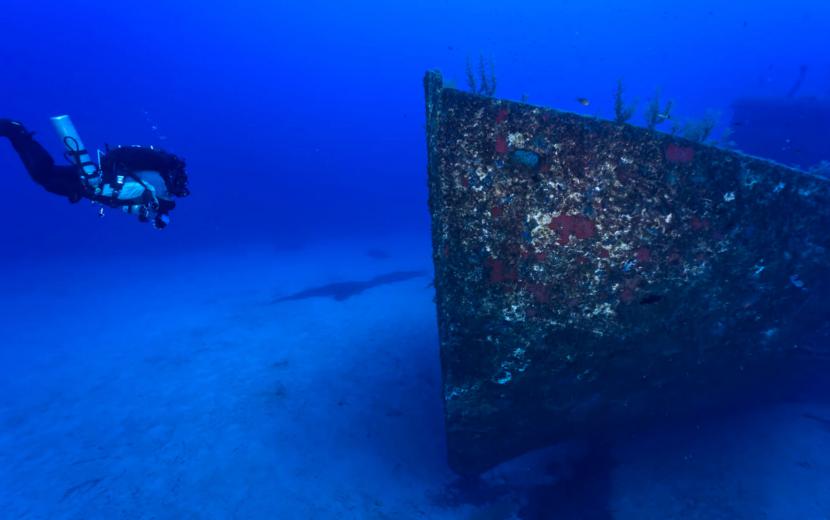 the diver is approaching Cominoland wreck underwater