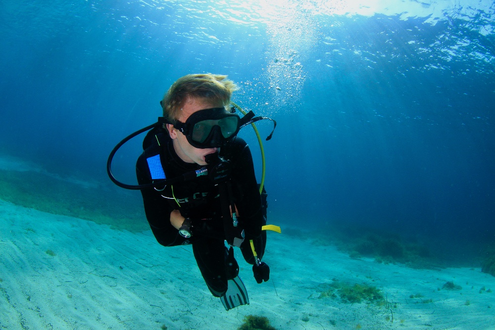 diver hovering in sunbeams